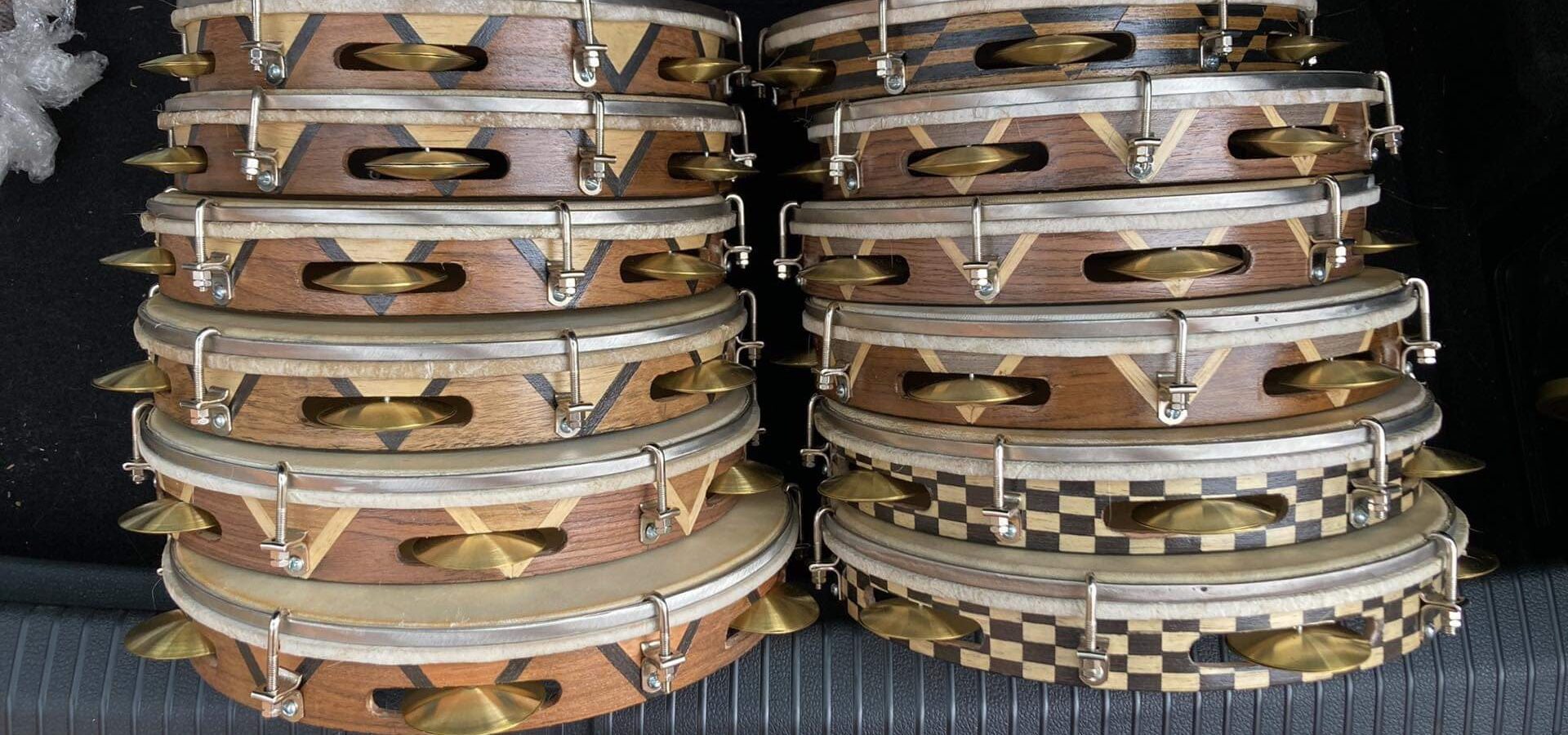 two stacks of wooden pandeiro drums