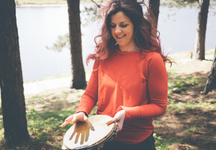 Holly percussionist playing a hand drum pandeiro